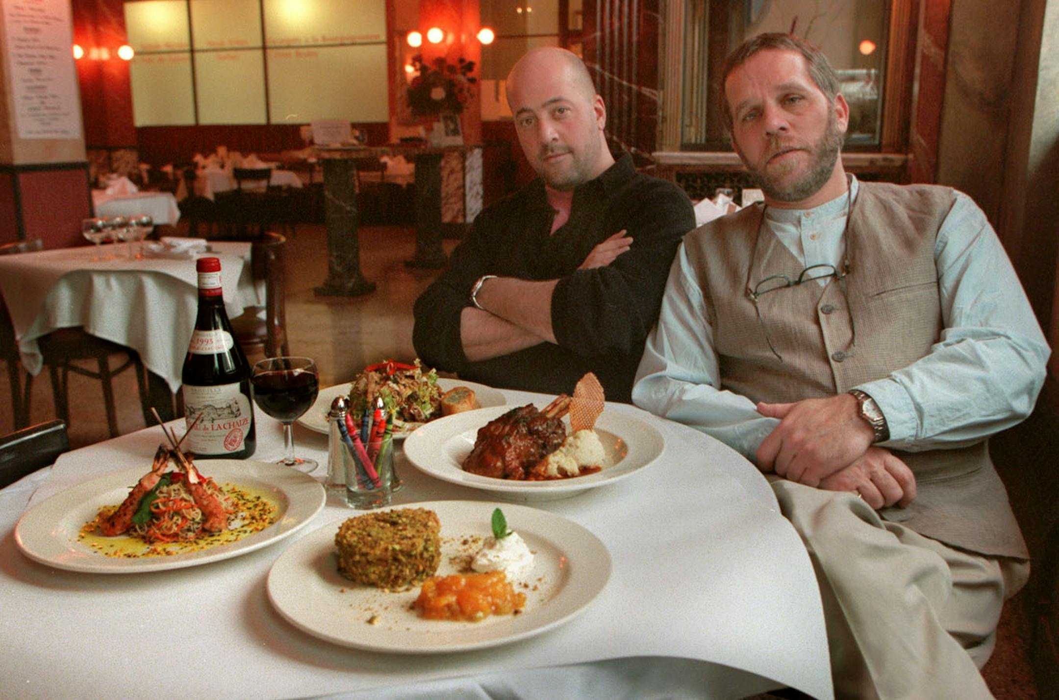 Andrew Zimmern, chef, left, and Michael Morse, owner of Cafe Un Deux Trois show off the items available in their prix fixe dinners.