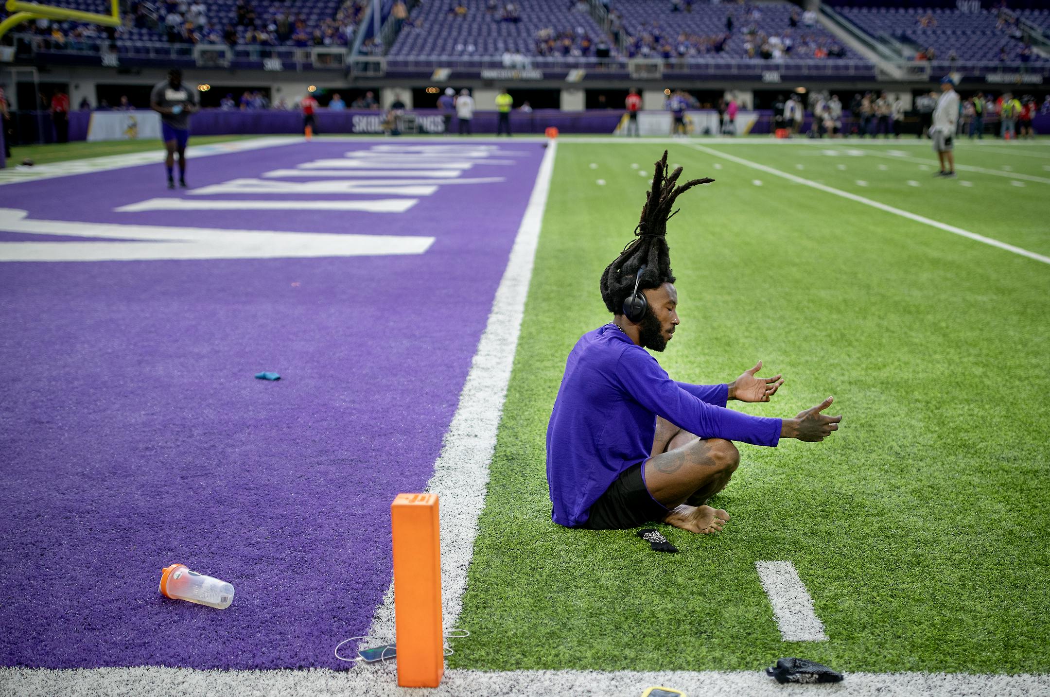 Vikings cornerback Harrison Hand meditates on the field before the game.