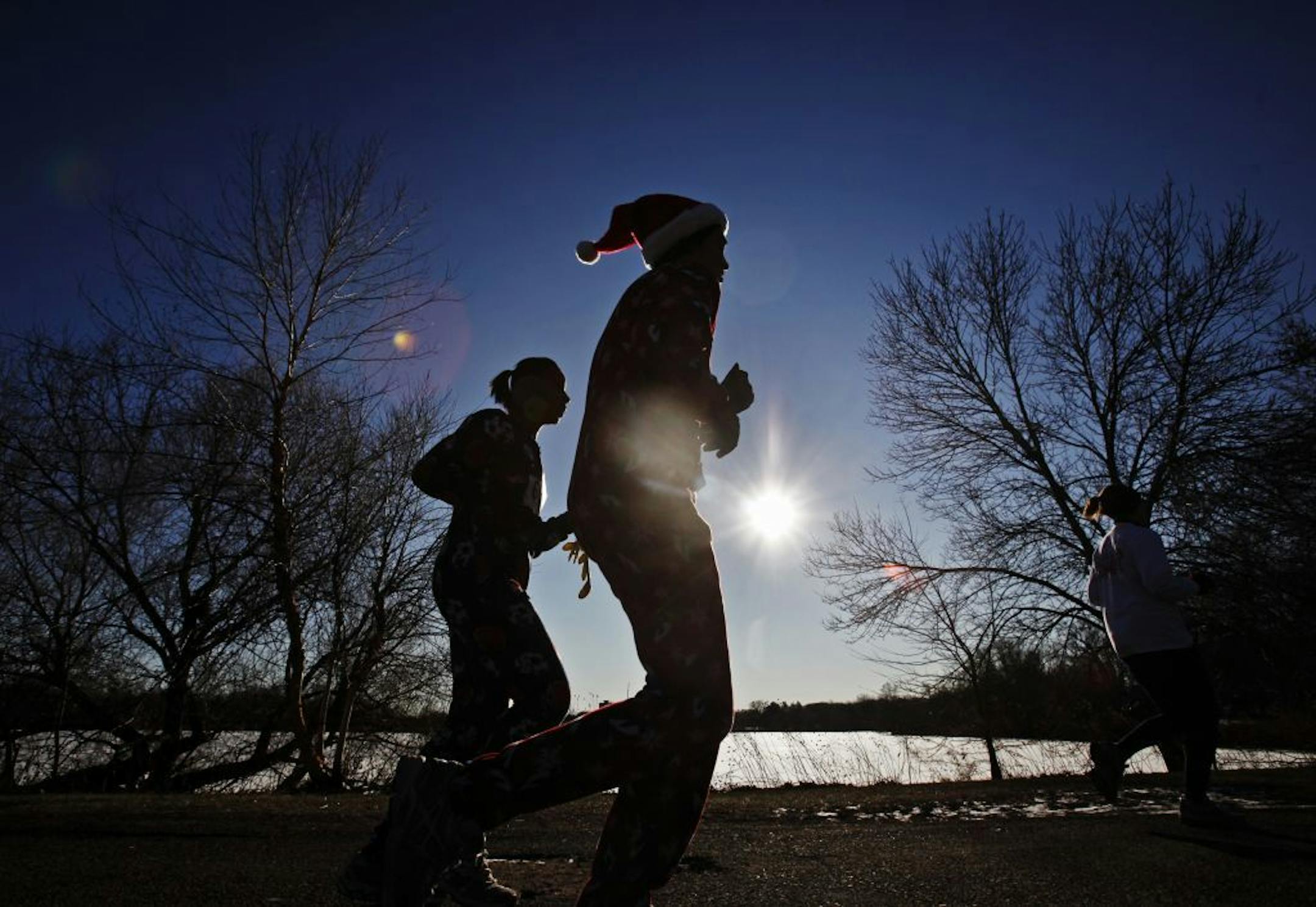 Under unusually warm, sunny skies runners made their way around Como Lake Sunday, Dec. 25, 2011 in St. Paul, during the Christmas Day - Joyful 5K run.