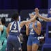 Minnesota Lynx guard Danielle Robinson (3) celebrates with center Sylvia Fowles (34) and Lexie Brown during the first half of the team's WNBA basketba