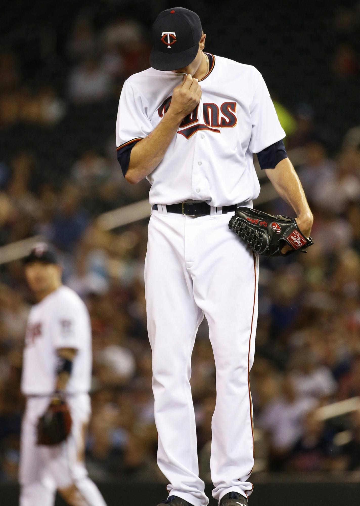 Minnesota Twins starting pitcher Kyle Gibson wipes his face after walking New York Yankees' Brian McCann during the seventh inning of a baseball game in Minneapolis, Thursday, June 16, 2016. (AP Photo/Ann Heisenfelt)