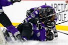 PWHL Minnesota players dogpile on forward Claire Butorac (7) after she scored in the second overtime period to give Minnesota the 1-0 win in a PWHL se