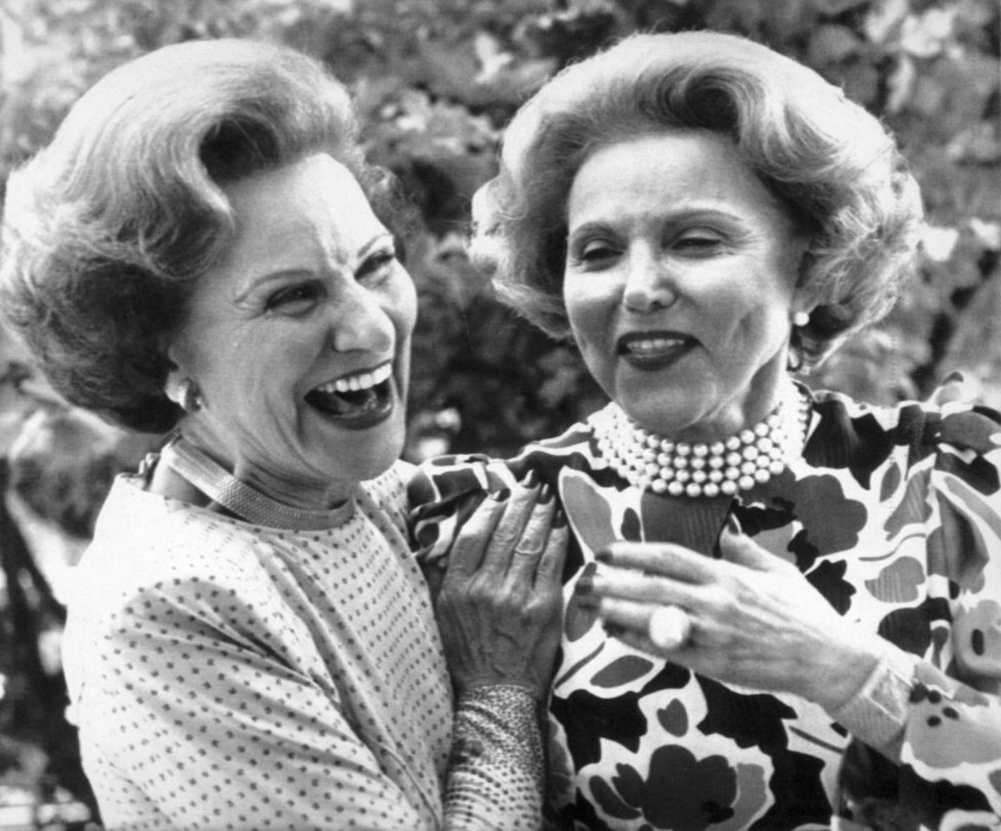 Famous advice columnists and twin sisters Abigail Van Buren (Pauline Friedman Phillips) (at left) and Ann Landers (right) shared a light moment after arriving in Sioux City, Iowa, Saturday June 21, 1986, to attend their 50th high school reunion.