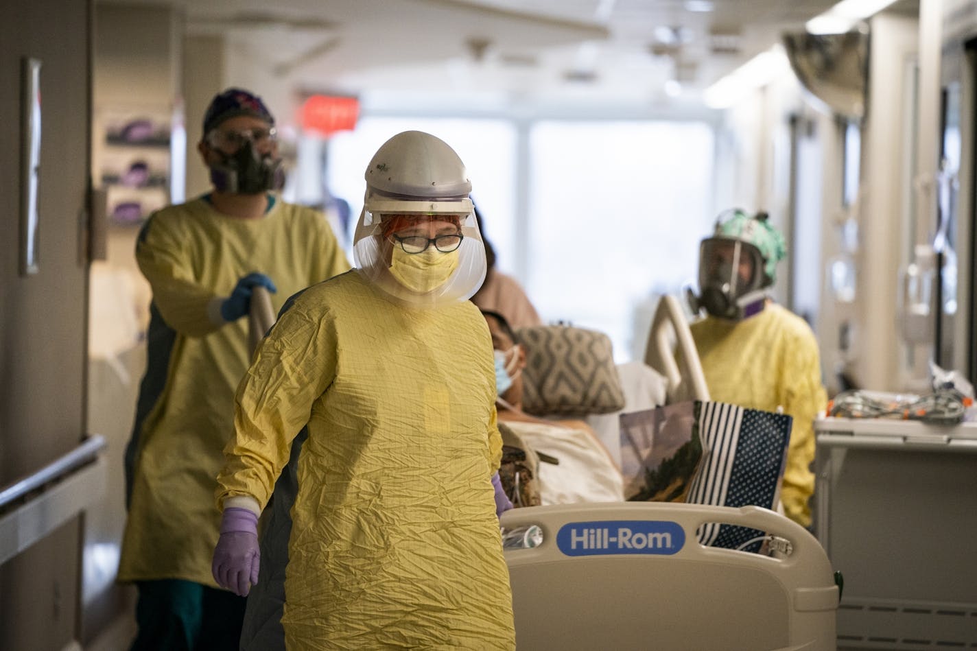 Amy Ressler Nelson, RN, brought a COVID-19 patient into the ICU from another floor of the hospital at Mercy Hospital in Coon Rapids.