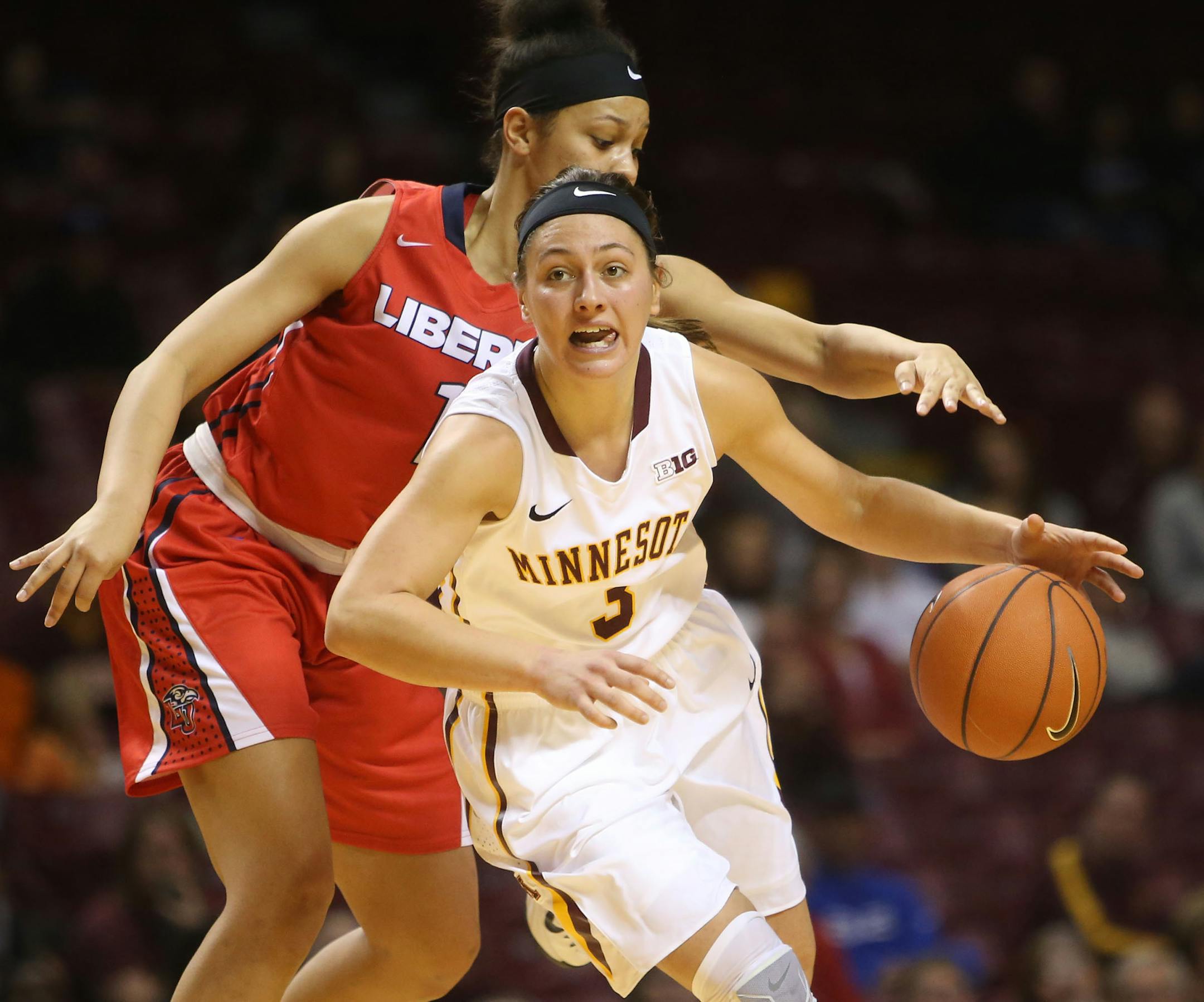 Minnesota's Shayne Mullaney is fouled by Liberty's Mickayla Sanders during the second half of the first round of the Subway Classic women's basketball tournament Saturday, Dec. 20, 2014, at Williams Arena.