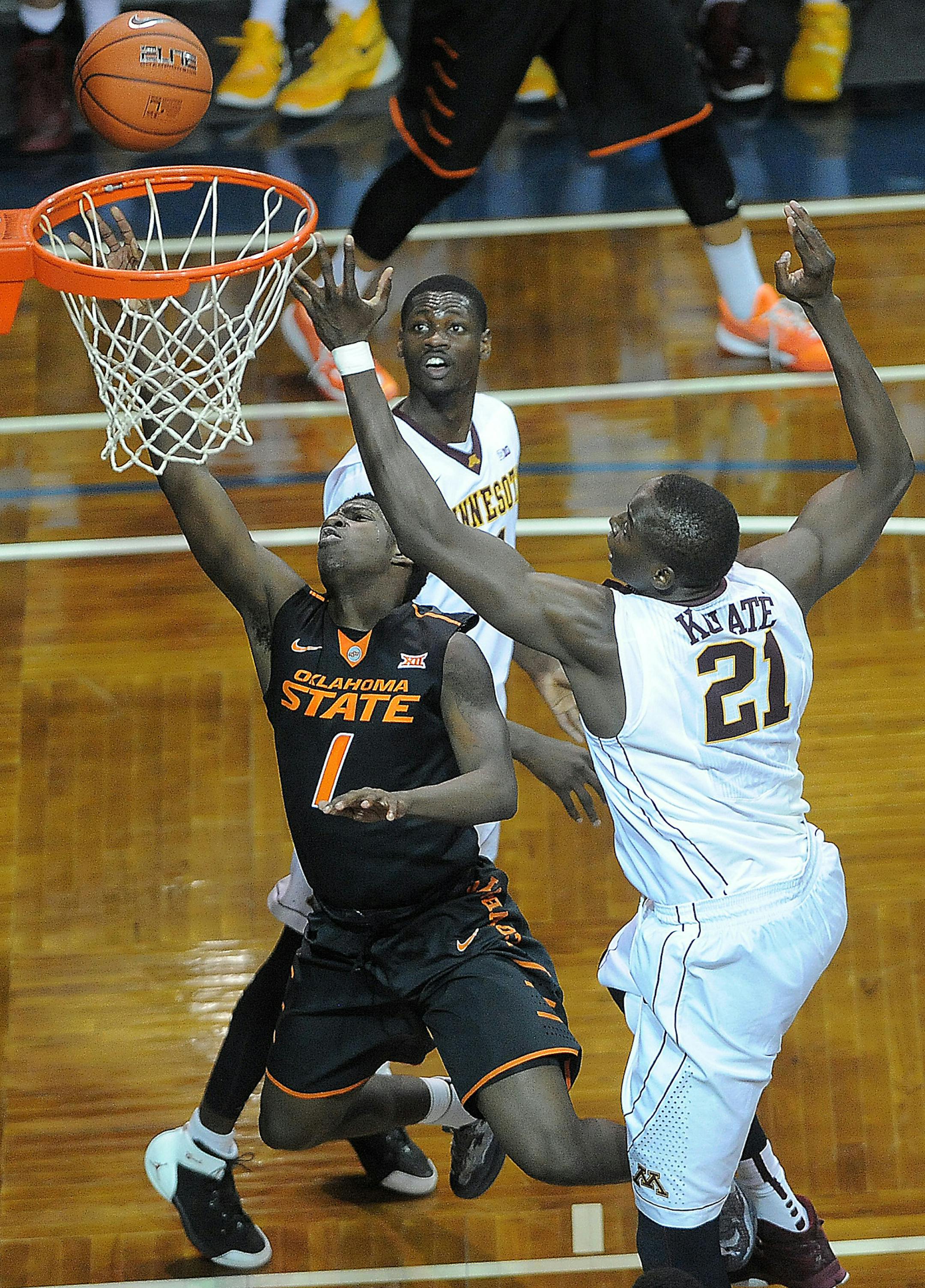 Oklahoma State's Jawun Evans (1) goes up for a shot while Minnesota's Bakary Konato (21) guards during their game at the Sanford Pentagon in Sioux Falls, S.D. on Saturday, Dec. 12, 2015. (Jay Pickthorn/The Argus Leader via AP) (AP Photo / Argus Leader, Jay Pickthorn)