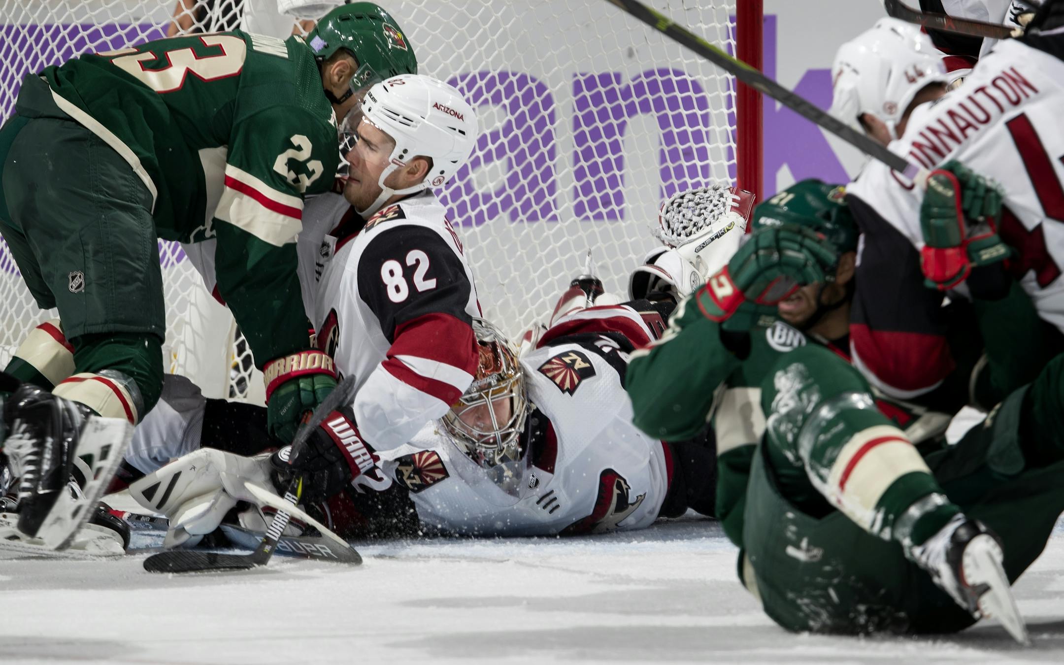 J.T. Brown (23) and Jordan Oesterle (82) fought for position by the net in the second period.