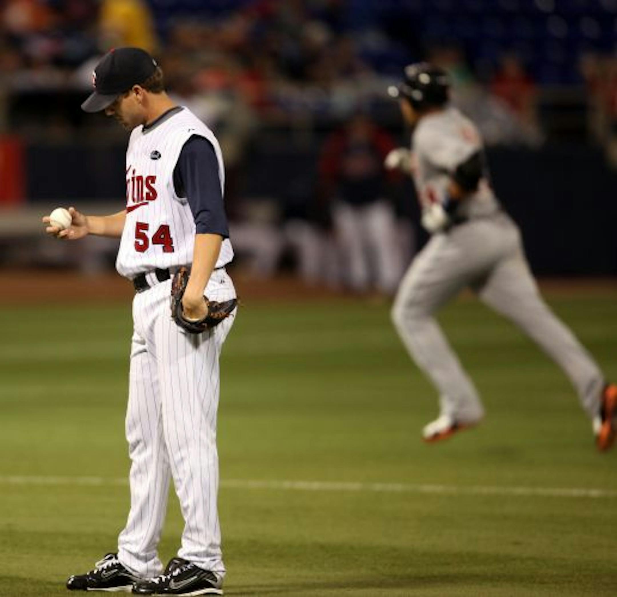 Twins' relief pitcher Matt Guerrier reacts after Tigers' Miguel Cabrera hit a three-run home run in the seventh inning
