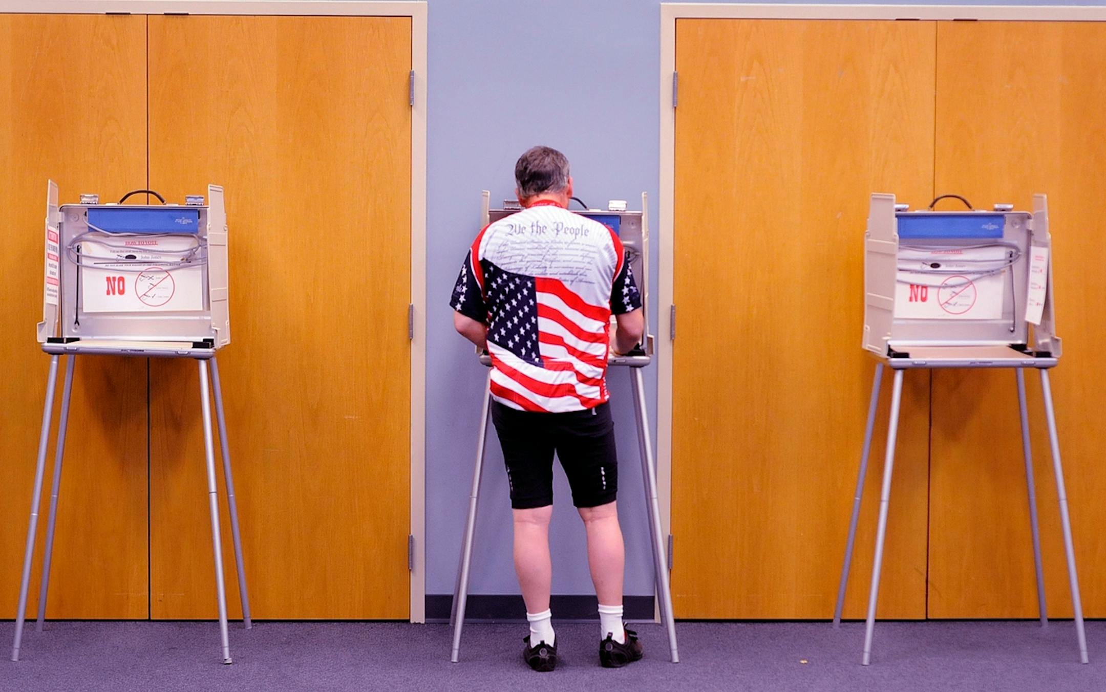 Robert Jewell who is a ''bicycle commuter'' votes in the Illinois primary election at the Bourbonnais Municipal Center in Bourgonnais, Ill., on Tuesday morning, March 20, 2012.