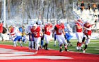 The Johnnies celebrate Dusty Krueger's (3) one-yard touchdown run on the game's final play, fourth-and-goal, in SJU's 32-31 win over UW-Platteville on