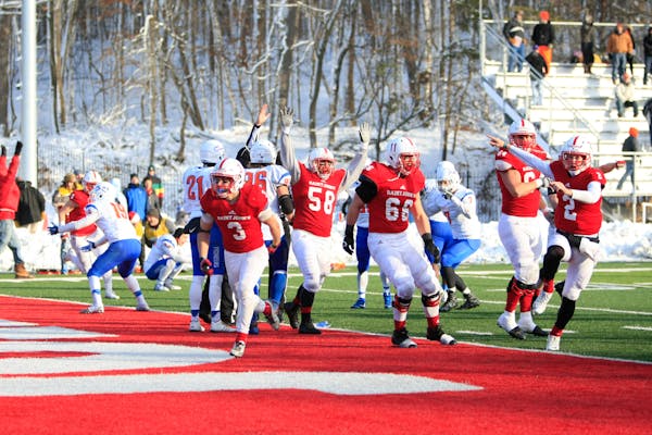 The Johnnies celebrate Dusty Krueger's (3) one-yard touchdown run on the game's final play, fourth-and-goal, in SJU's 32-31 win over UW-Platteville on