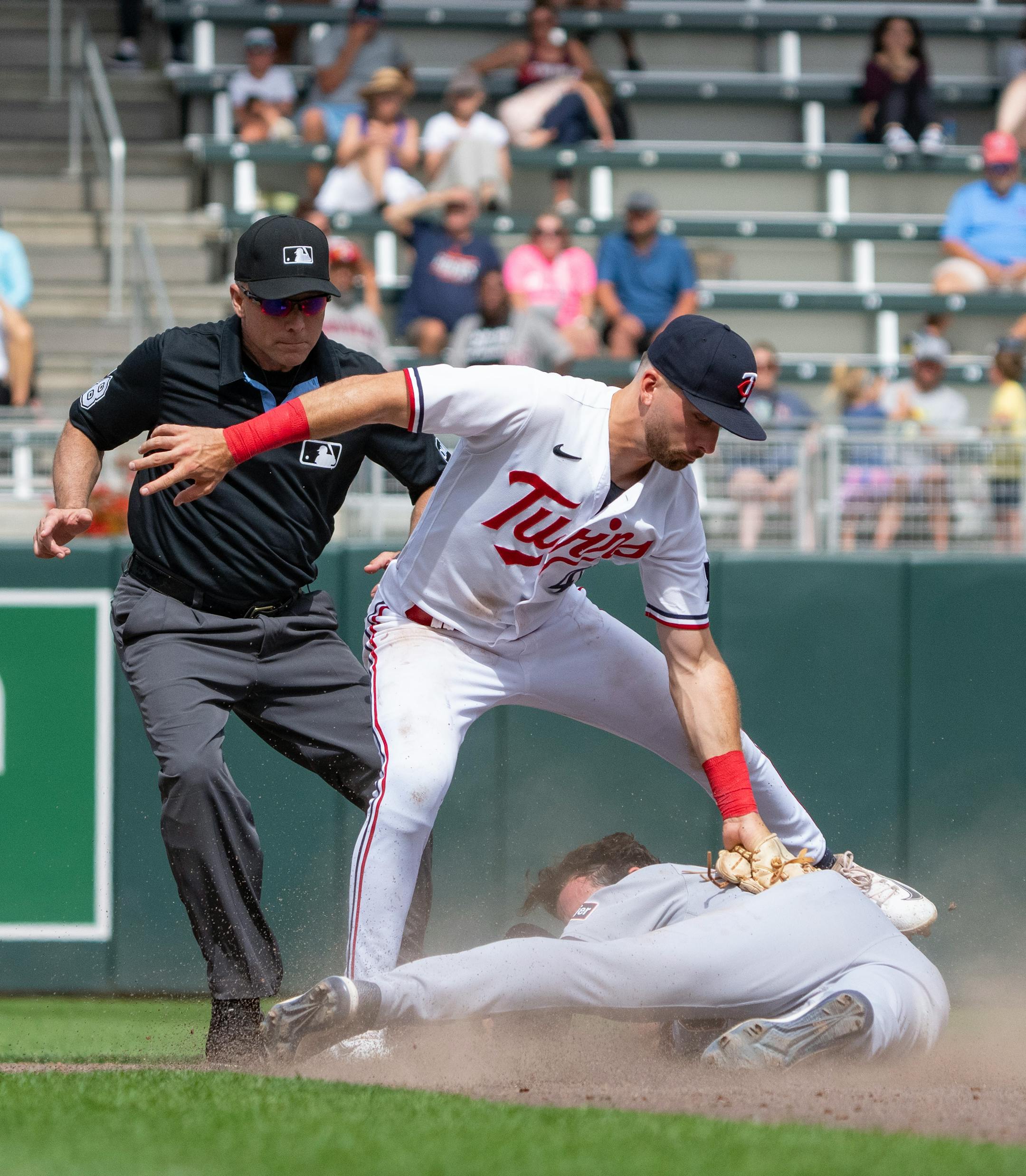 Minnesota Twins second baseman Edouard Julien (47) tags out Detroit Tigers right fielder Matt Vierling (8) as he tries to steal second base in the ninth inning.