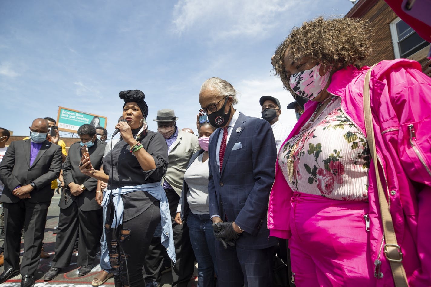 Rev. Al Sharpton (center) and Gwen Carr the mother of Eric Garner prayed at the site where George Floyd was killed .