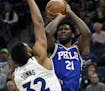 Timberwolves center Karl-Anthony Towns (32) guarded 76ers center Joel Embiid (21) during the first quarter Tuesday,