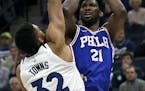Timberwolves center Karl-Anthony Towns (32) guarded 76ers center Joel Embiid (21) during the first quarter Tuesday,