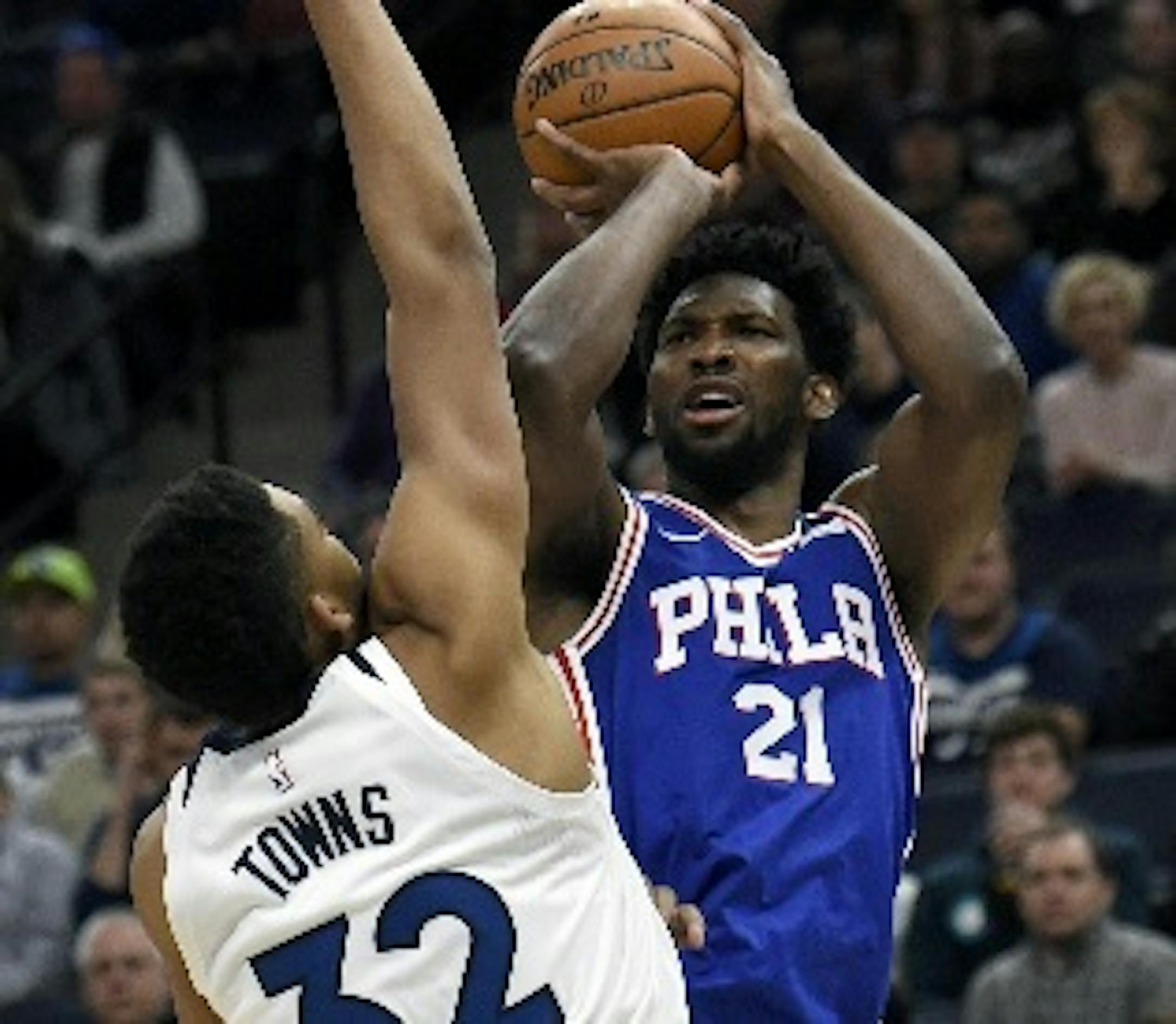 Timberwolves center Karl-Anthony Towns (32) guarded 76ers center Joel Embiid (21) during the first quarter Tuesday,