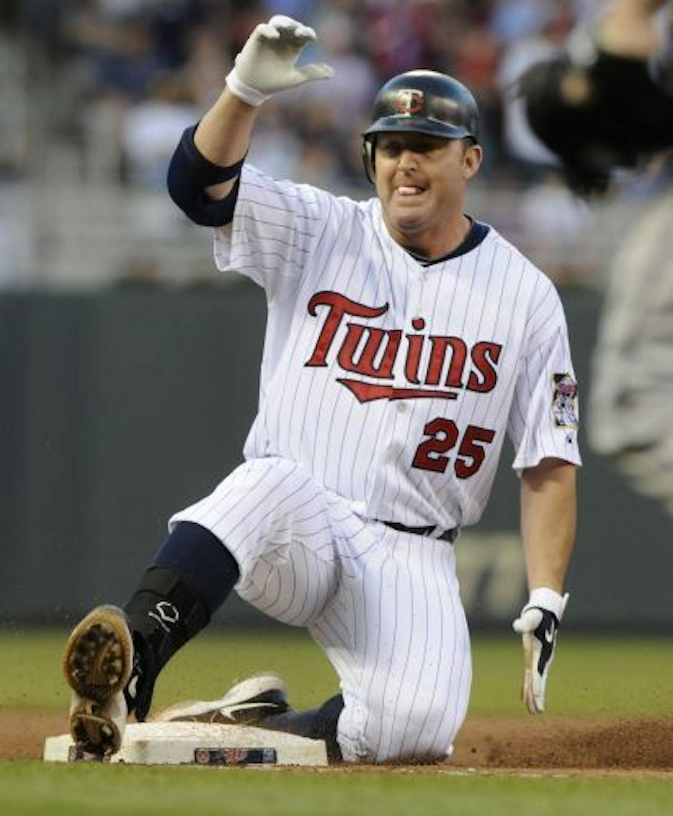 Minnesota Twins' Jim Thome slides into third with a triple off Detroit Tigers pitcher Jeremy Bonderman in the fourth inning of a baseball game Monday, June 28, 2010 in Minneapolis.