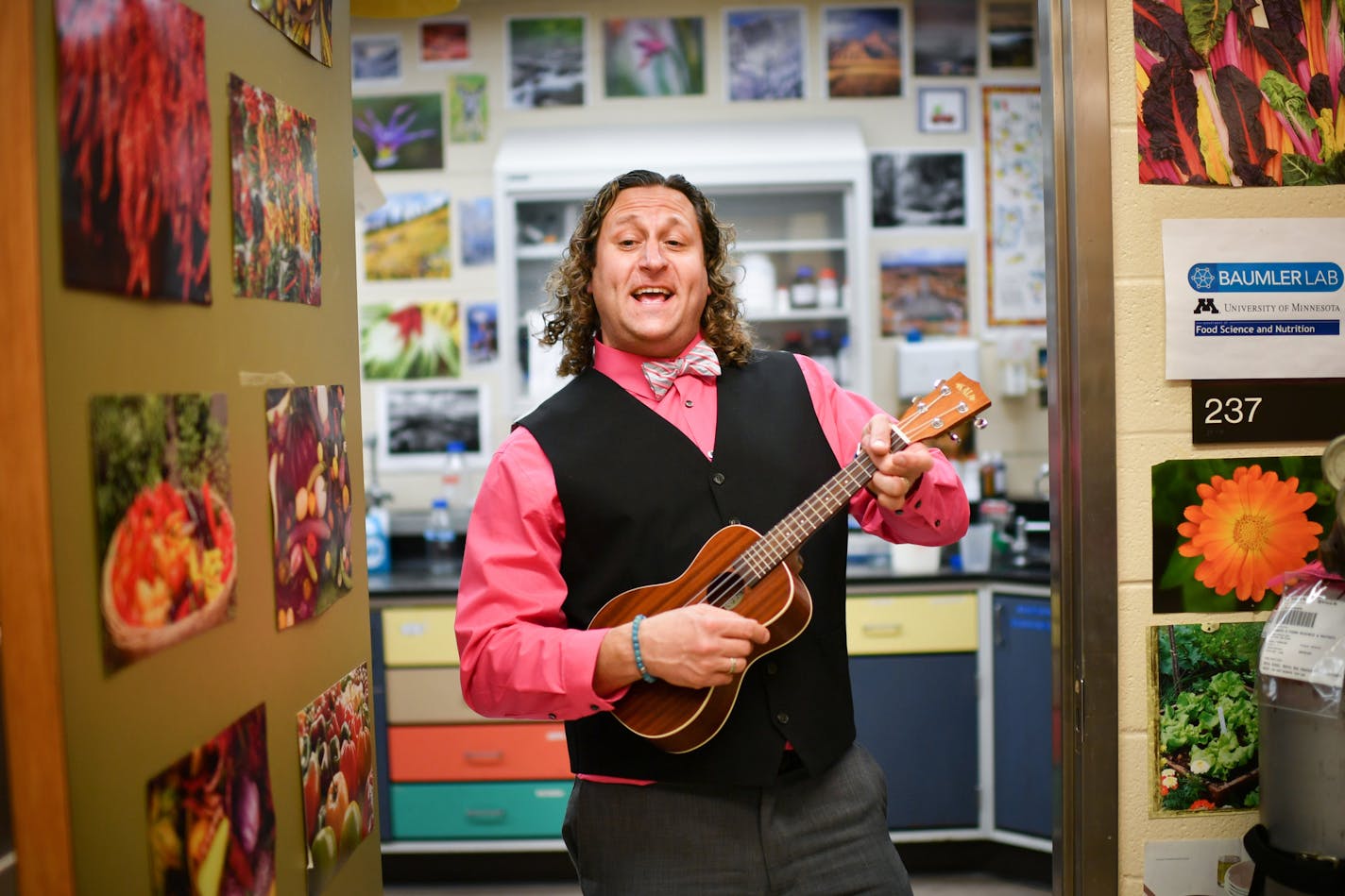 Photos of hot peppers help brighten U Prof. David Baumler's lab, where he and students filmed a music video that garnered enough hits to win the lab a $40,000 piece of equipment. Baumler sometimes plays the ukulele in class. He also plays the saxophone as Davey Doodle, leading a rock band aimed at preschoolers.