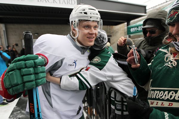 Wild center Mikael Granlund received a big hug from a small fan before he made his way to a short outdoor practice at the Backyard outdoor ice rink at
