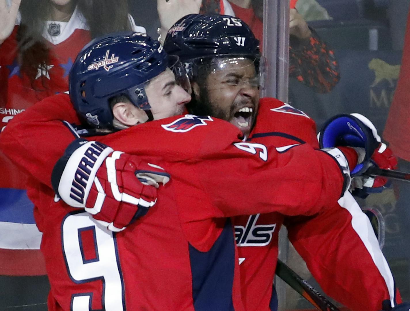 Washington Capitals defenseman Dmitry Orlov (9), from Russia, and right wing Devante Smith-Pelly (25) celebrate Smith-Pelly's goal with Tampa Bay Lightning right wing Nikita Kucherov (86), from Russia, nearby during the third period of Game 6 of the NHL Eastern Conference finals hockey playoff series, Monday, May 21, 2018, in Washington. The Capitals won 3-0. (AP Photo/Alex Brandon)