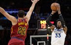 Minnesota Timberwolves' Robert Covington (33) shoots against Cleveland Cavaliers' Larry Nance Jr. (22) in the second half of an NBA basketball game, M