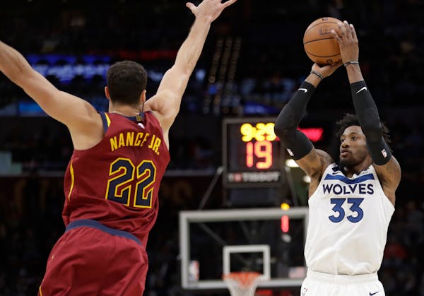 Minnesota Timberwolves' Robert Covington (33) shoots against Cleveland Cavaliers' Larry Nance Jr. (22) in the second half of an NBA basketball game, M