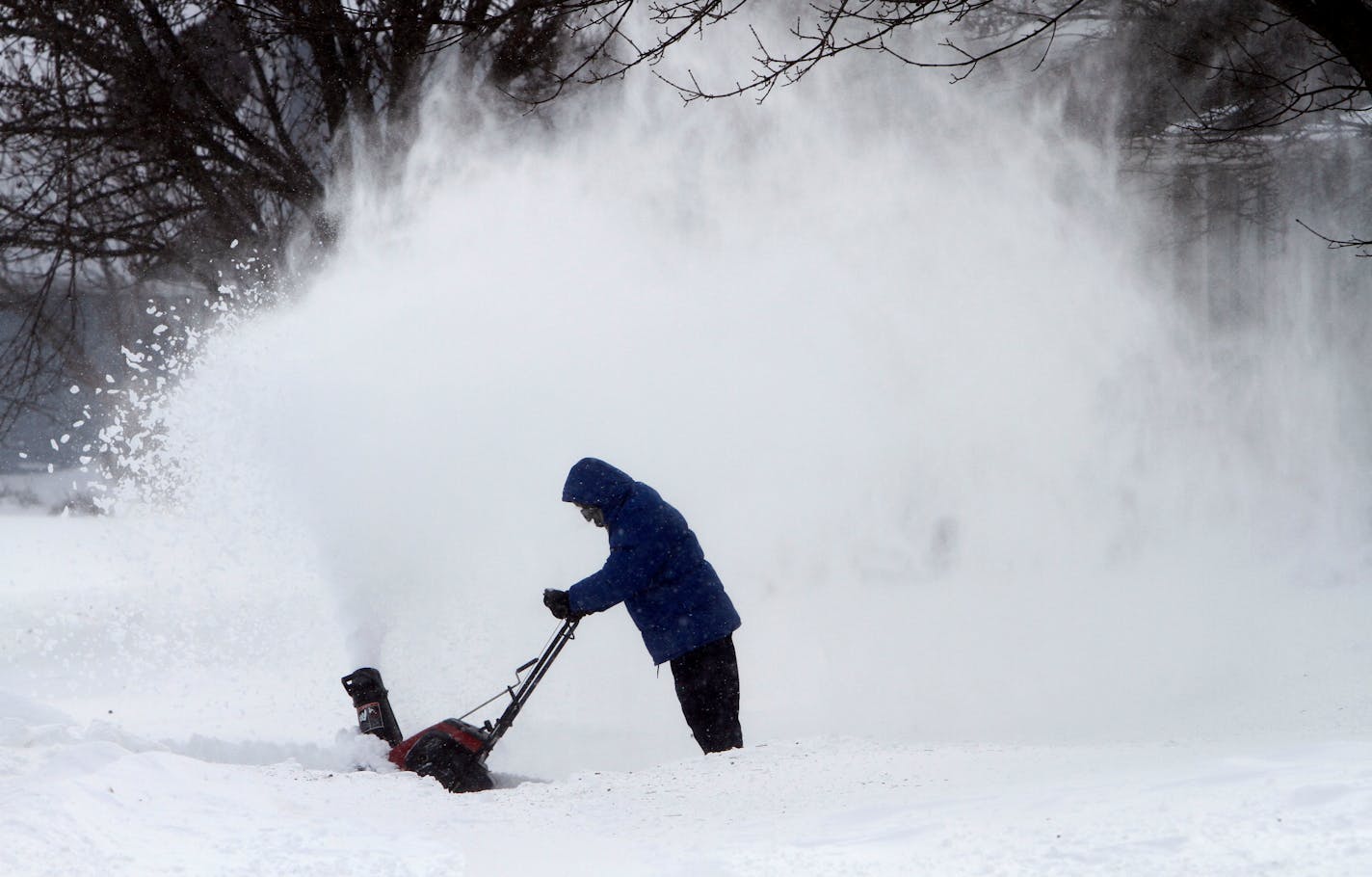 A local resident clears snow from his driveway, Wednesday, Dec. 9, 2009, in Des Moines, Iowa. More than a foot of snow was expected in parts of Illinois, Wisconsin and Iowa, where the National Weather Service warned of "extremely dangerous blizzard conditions" and near whiteout driving conditions. Wind gusts of up to 50 mph could build snow drifts between 8 and 15 feet tall. (AP Photo/Charlie Neibergall)