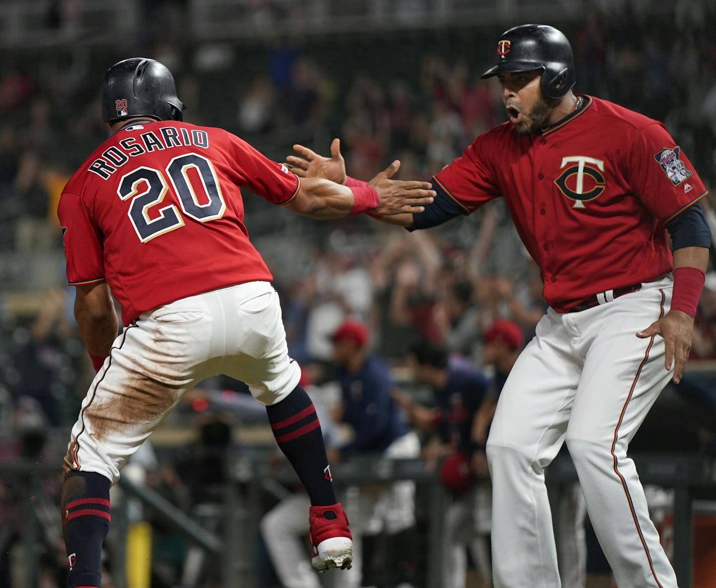 Minnesota Twins right fielder Eddie Rosario (20), and Minnesota Twins designated hitter Nelson Cruz (23) celebrated scoring in the 12th inning. ] LEILA NAVIDI • leila.navidi@startribune.com BACKGROUND INFORMATION: The Minnesota Twins play the Chicago White Sox at Target Field in Minneapolis on Tuesday, September 17, 2019. The Minnesota Twins won 9-8 in a 12th inning walk-off after Minnesota Twins second baseman Ronald Torreyes (74) was hit by a pitch while the bases were loaded.