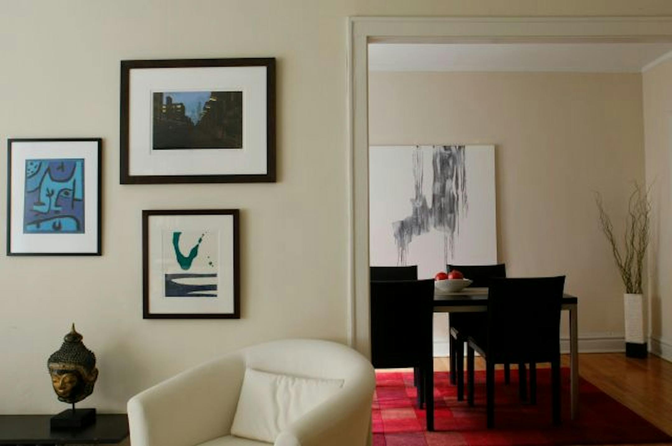Instead of restraining yourself to a gallery wall with coordinating frames, decorate your home a melange of pieces from your travels: prints, photographs, sculptures and more.