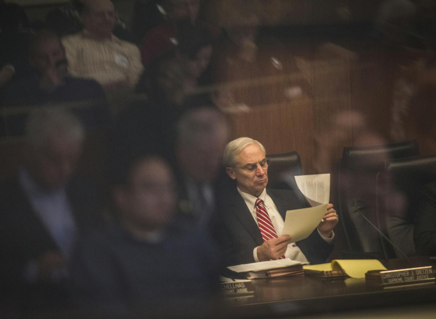 Supreme Court Justice Christopher J. Dietzen looked through papers while listening to testimonies during Wednesday's public hearing on drug sentencing reform. ] (AARON LAVINSKY/STAR TRIBUNE) aaron.lavinsky@startribune.com The Minnesota Sentencing Guidelines Commission is advancing a proposal to reform drug sentencing rules. It held a public hearing at the State Office Building on Wednesday, Dec. 23, 2015 in St. Paul. Faith and community activists in favor of sentencing reform spoke prior to the