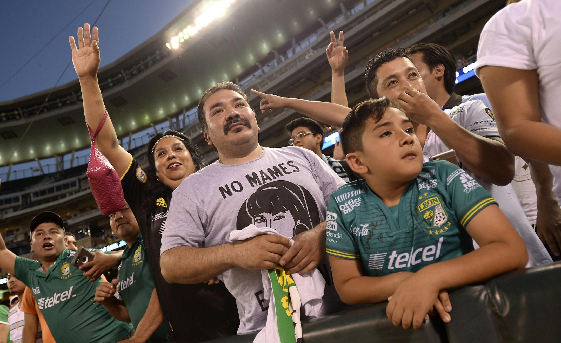 Jose Cruz, center, of Milwaukee, vied for the attention of Club Leon player for autographs after Saturday night's game. ] (AARON LAVINSKY/STAR TRIBUNE) aaron.lavinsky@startribune.com Minnesota United played the León Fútbol Club on Saturday, June 25, 2016 at Target Field in Minneapolis, Minn.