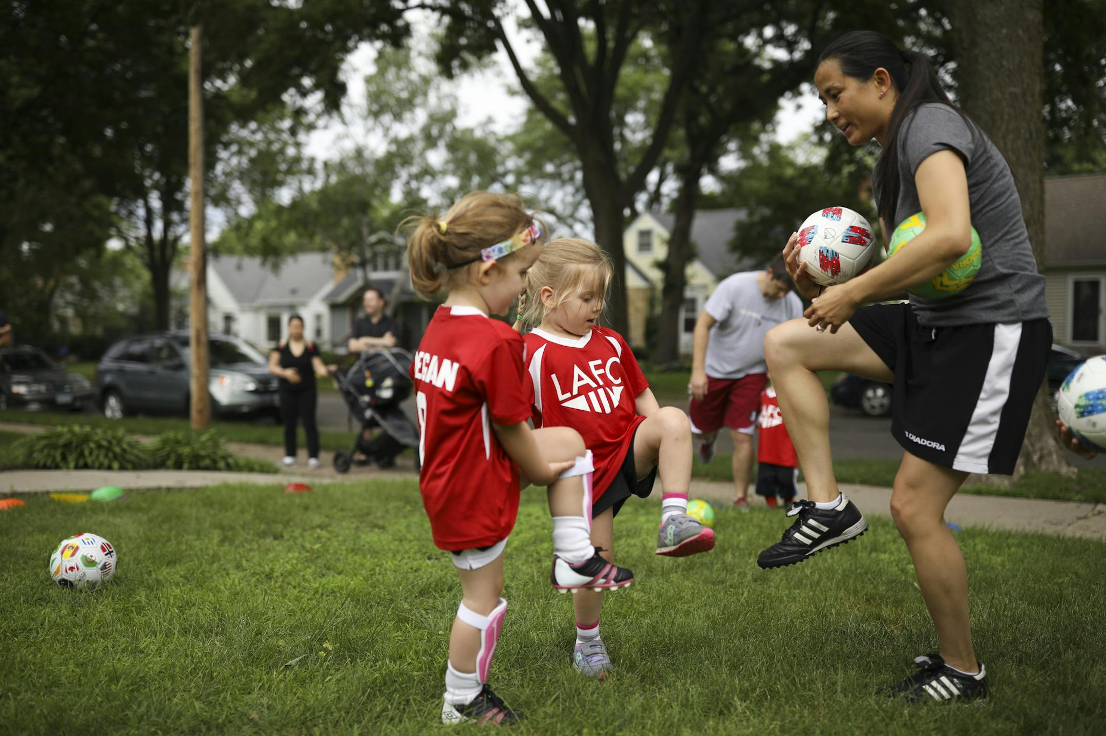 Coach Anna Amankwa worked with Megan Makarov, left, and Eleanor Gingo on their ball control skills during practice. ] JEFF WHEELER ï jeff.wheeler@startribune.com There's a one block stretch of Logan Ave. S. in the Kenny neighborhood of southwest Minneapolis that has 20 kids under five years old. It wasn't much of a stretch to form their own soccer team, the Logan Ave. Football Club. One of the block's moms, former U of M player Anna Amankwa, created a practice schedule for the 10 week clini