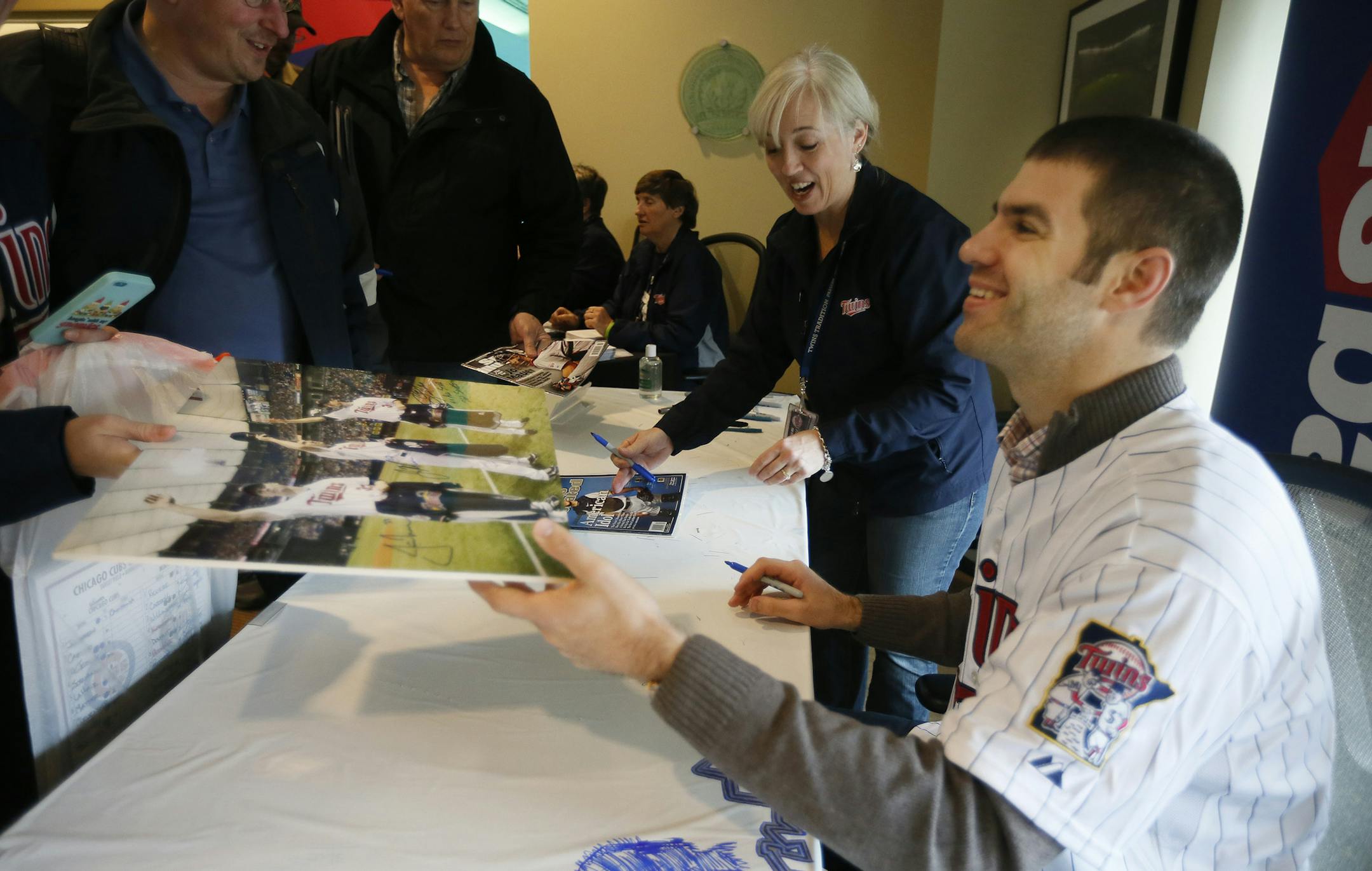 Joe Mauer autographed a photo for a fan during the last day of Twinsfest at Target Field Sunday January 26, 2014 in Minneapolis ,MN.] JERRY HOLT ‚Ä¢ jerry.holt@startribune.com