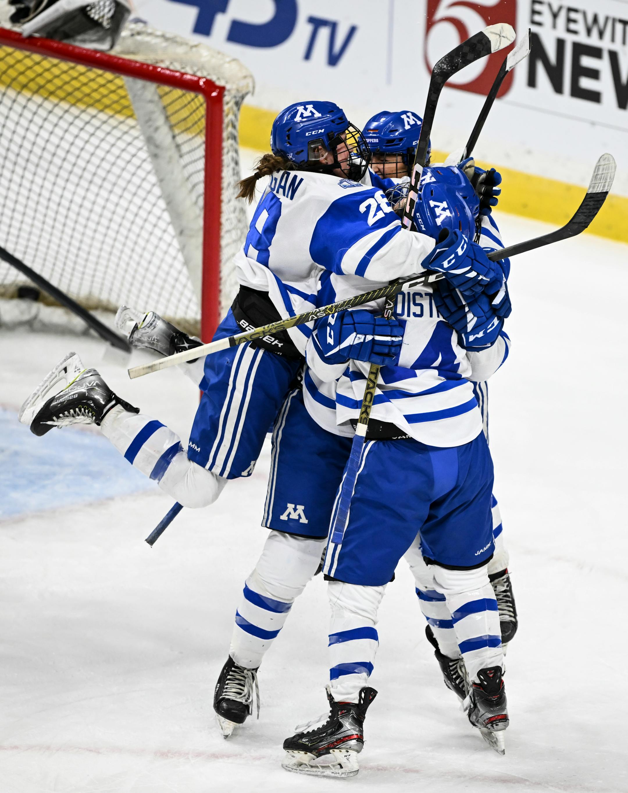 Teammates celebrate with Minnetonka forward Lindzi Avar (13) after she scored the game-winning goal against Centennial/Spring Lake Park during the third period.
