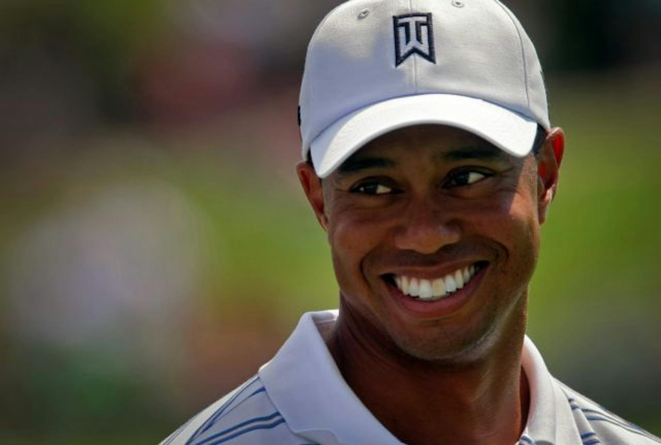 Tiger Woods cracked a smile while spending some time on the practice range Monday afternoon at Hazeltine National Golf Club prior to the start of the 91st PGA Championship.