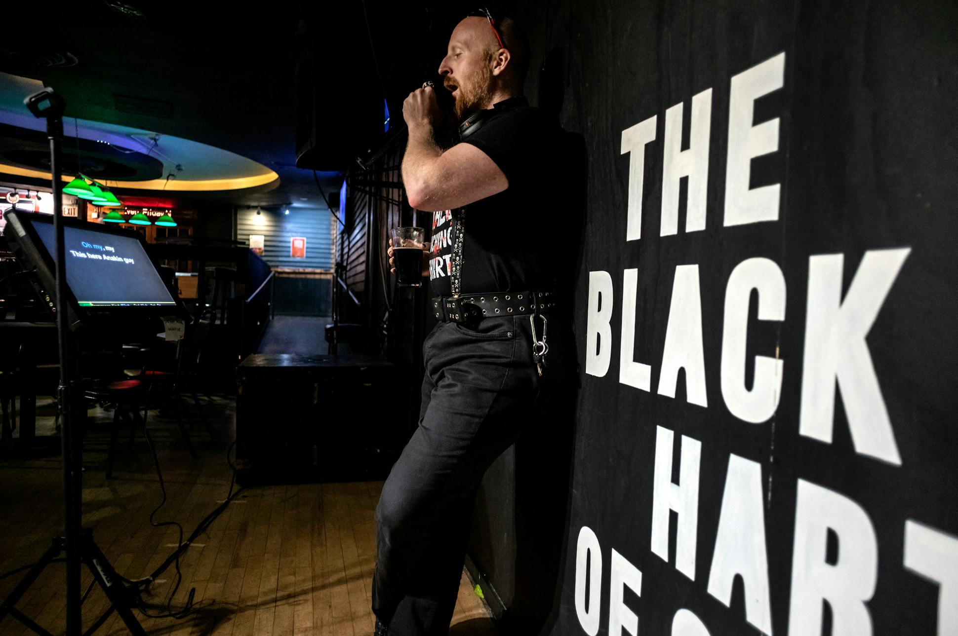 Christopher Schmidt sings during Tuesday night karaoke at the Black Hart of St. Paul bar Aug. 1, 2023.