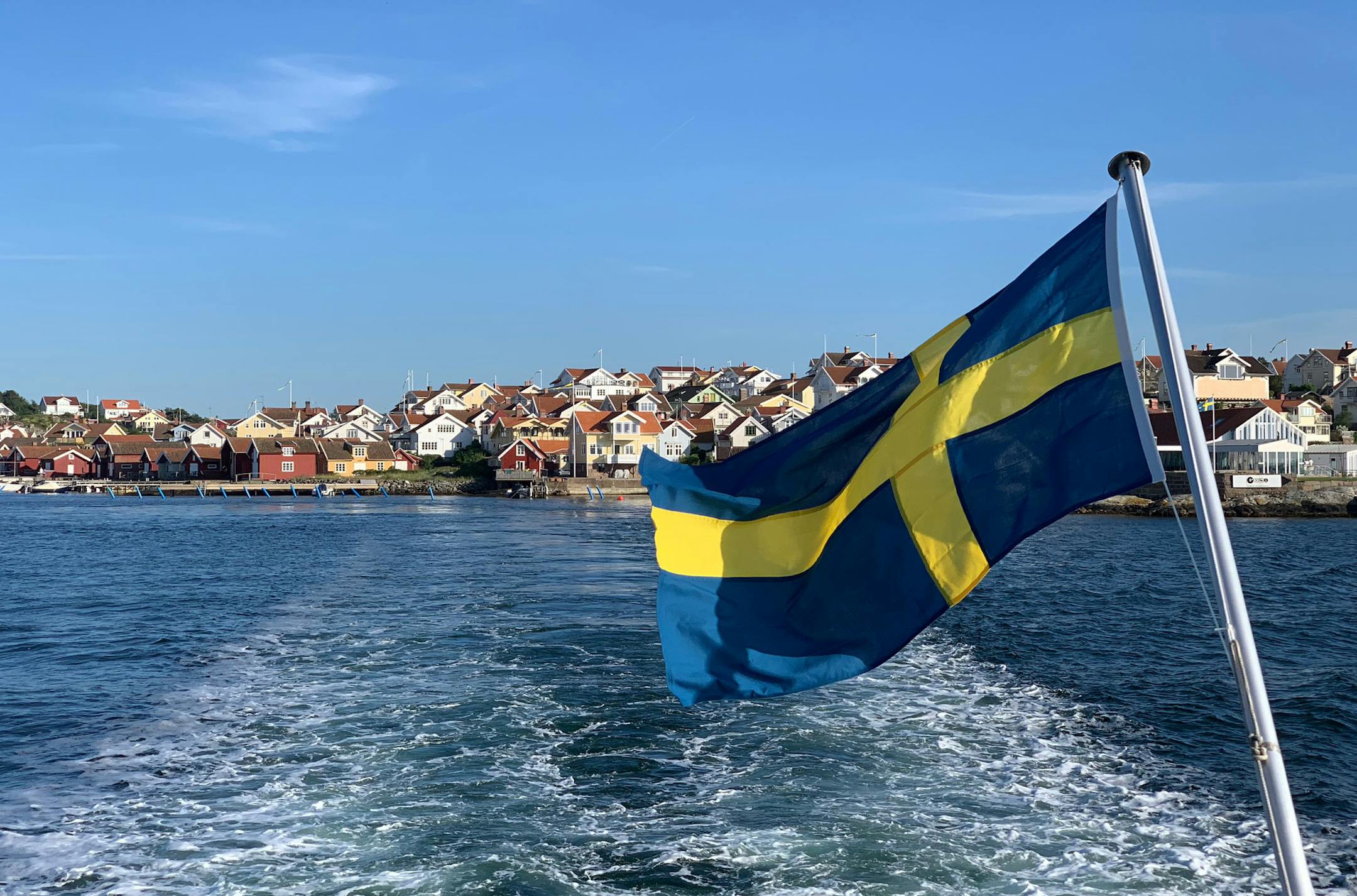 A Swedish flag flies behind a ferry departing Fiskebackskil, a Swedish island. Photo by Raphael Kadushin, special to the Star Tribune