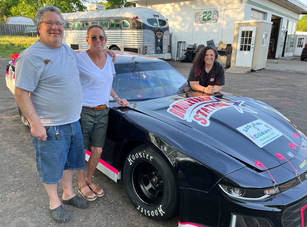 Taylor Goldman, right, and her parents Dave and Jane, with her Thunder Car.