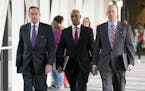 Former Minneapolis police officer Mohamed Noor, center, arrives for the first day of jury selection with his attorneys Peter Wold, left, and Thomas Pl