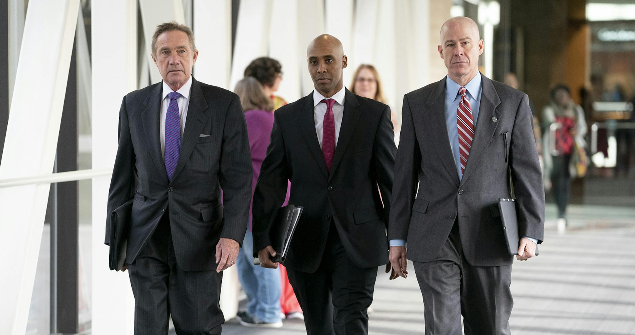 Former Minneapolis police officer Mohamed Noor, center, arrives for the first day of jury selection with his attorneys Peter Wold, left, and Thomas Plunkett, right, on Monday, April 1, 2019 at the Hennepin County Government Center in Minneapolis.