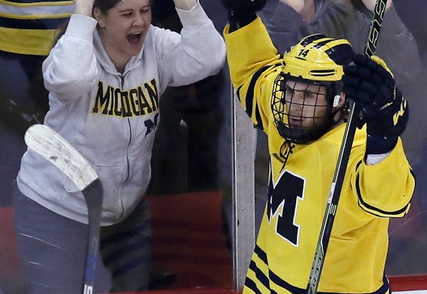 Michigan's Tyler Motte celebrates his goal against Michigan State during the second period of a college hockey game at Joe Louis Arena on Friday, Feb.