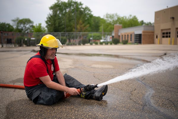 Michael Culhane sprayed water during a training exercise Sunday at the St. Anthony Village Public Works facility in St. Anthony. Michael Culhane was s