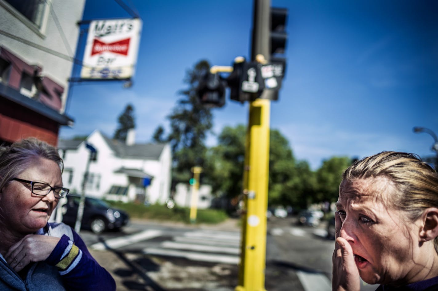 AnnDee Gunderson, left, and Natasha Gunderson became emotional recalling their cousin Kimberly Gunderson, who died in a crash last September in front of Matt's Bar. They left a bouquet of roses for her cousin.