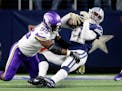 Dallas Cowboys running back Ezekiel Elliott (21) is wrapped up by Minnesota Vikings defensive end Ifeadi Odenigbo (95) late in the fourth quarter