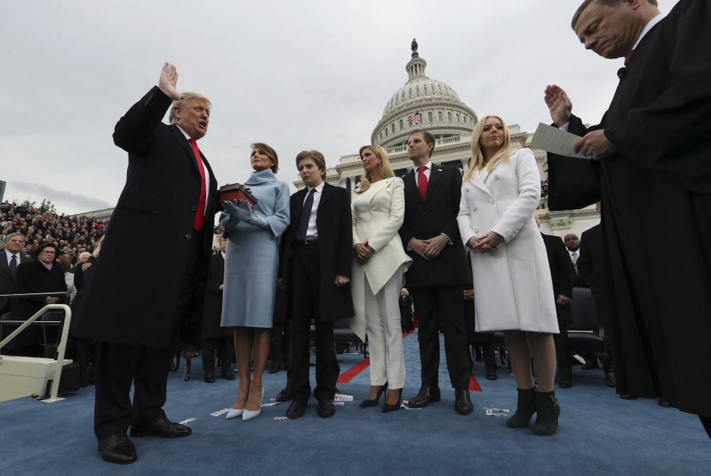 President Donald Trump takes the oath of office from Chief Justice John Roberts, as his wife Melania holds the bible, and with his children Barron, Ivanka, Eric and Tiffany, Friday, Jan. 27, 2017 on Capitol Hill in Washington.