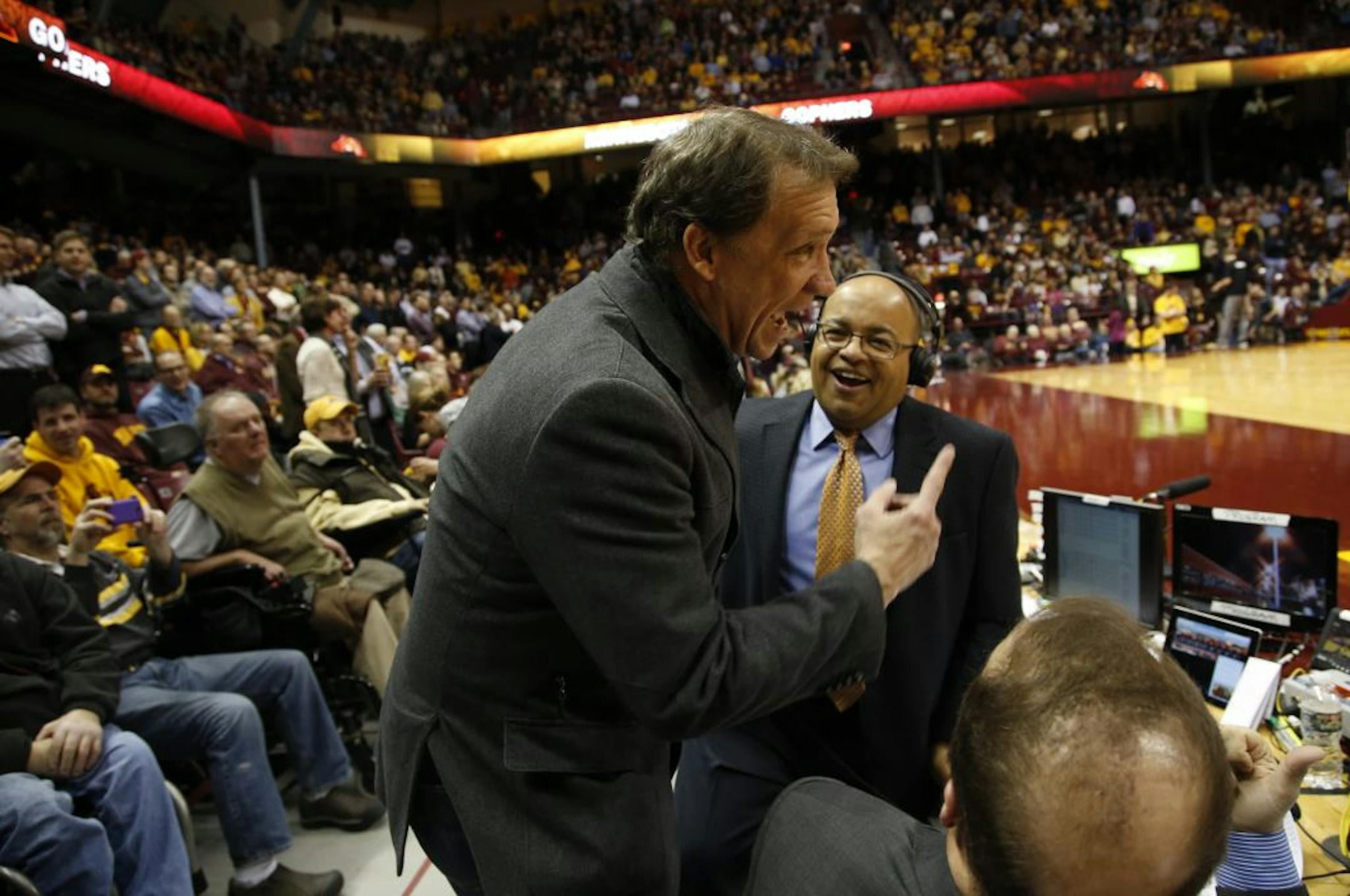 Former Timberwolves coach Flip Saunders talked with ESPN commentators Mike Tirico, behind, and Dan Dakich during halftime of the Gophers-Indiana game at WIlliams Arena on Tuesday.