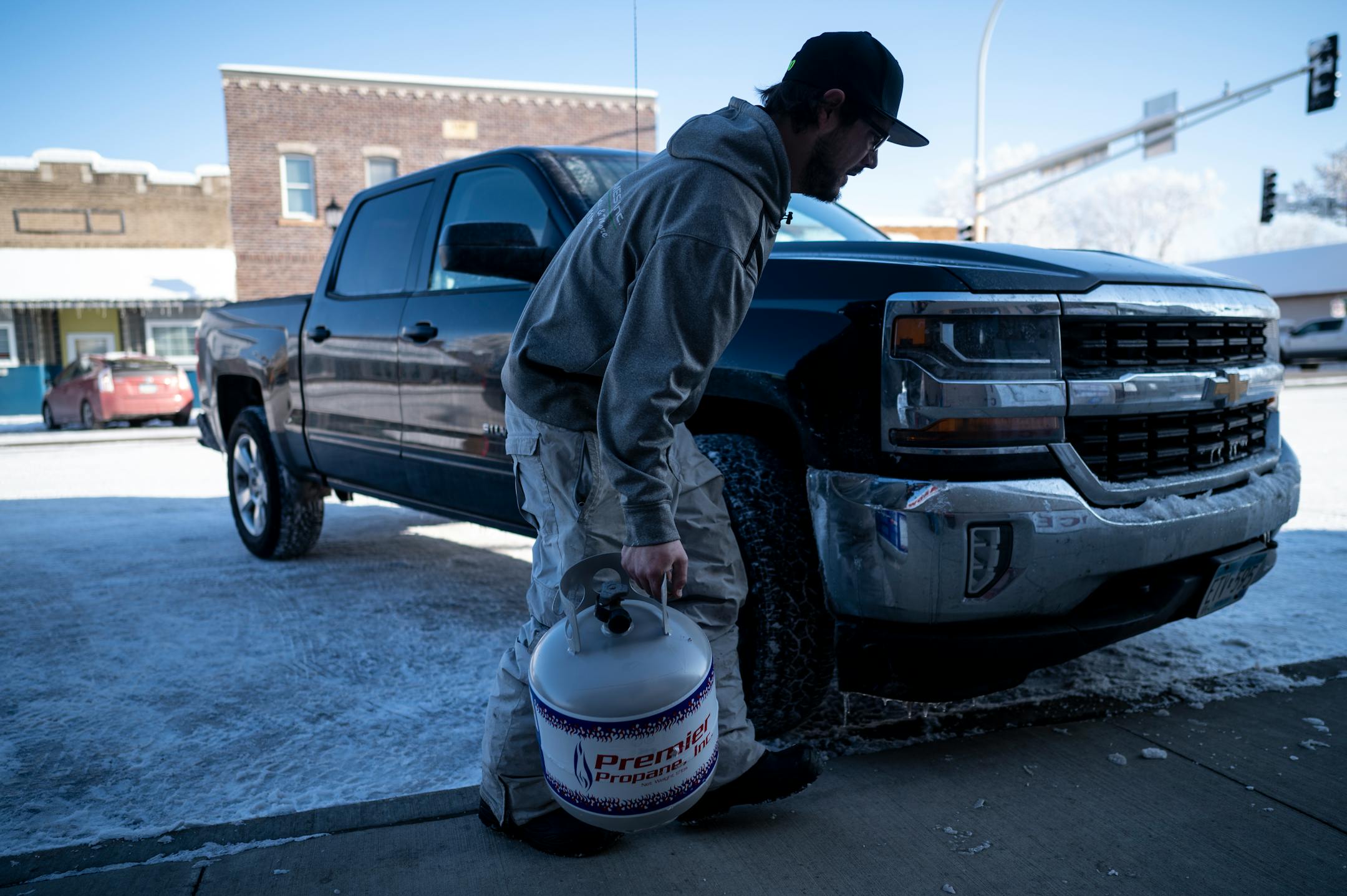 Ben Jerin, of Lonsdale, carries a gas canister to his truck outside Lonsdale Hardware and Rental.