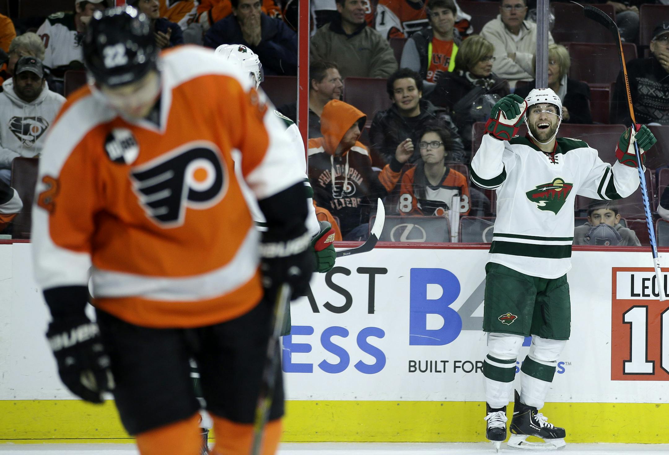 Minnesota Wild's Jason Zucker, right, celebrates as Philadelphia Flyers' Luke Schenn skates by after Zucker scored the go-ahead goal during the third period of an NHL hockey game, Thursday, Nov. 20, 2014, in Philadelphia. Minnesota won 3-2. (AP Photo/Matt Slocum)