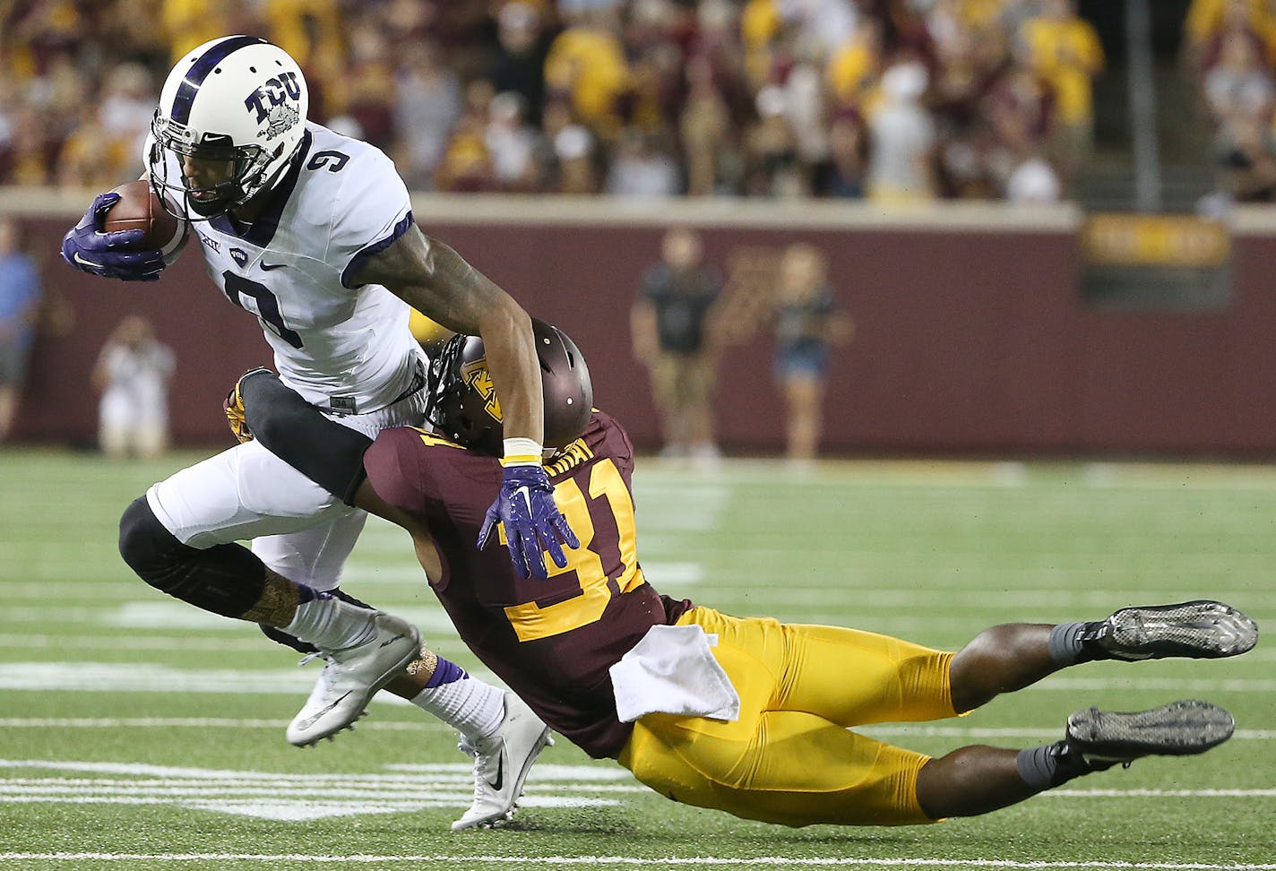 TCU Horned Frogs wide receiver Josh Doctson is tackled by Minnesota Gophers defensive back Eric Murray as he carried the ball in the second quarter as the Gophers took on TCU at TCF Stadium, Thursday, September 3, 2015 in Minneapolis, MN. ] (ELIZABETH FLORES/STAR TRIBUNE) ELIZABETH FLORES &#x2022; eflores@startribune.com