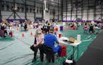 A woman sat waiting to be vaccinated at the Vikings Training Center that'd been converted into a site administering the newly available, single-dose, 